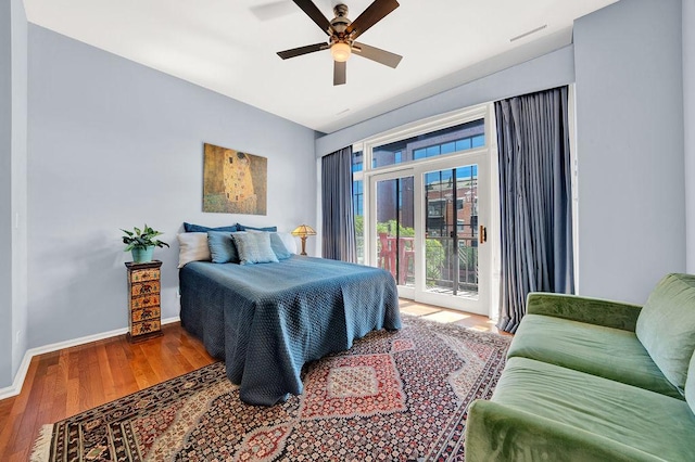 bedroom with hardwood / wood-style floors, access to exterior, and ceiling fan