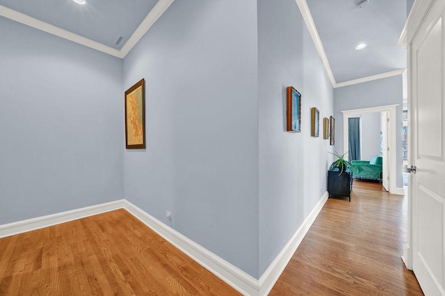 hallway featuring crown molding and hardwood / wood-style flooring