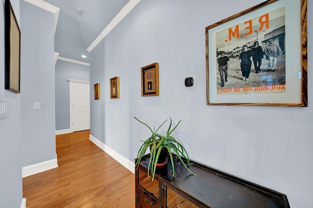 corridor with crown molding and light wood-type flooring