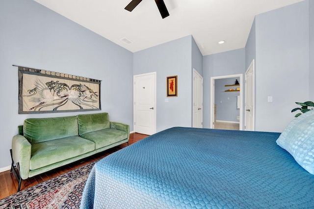 bedroom with ceiling fan, wood-type flooring, and connected bathroom