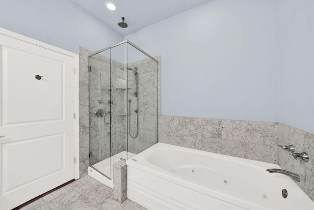 bathroom featuring separate shower and tub