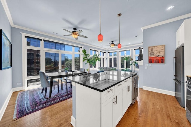 kitchen with wine cooler, appliances with stainless steel finishes, dark stone counters, and white cabinets