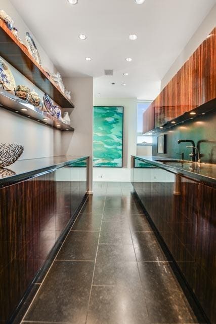 kitchen with dark tile patterned flooring and sink