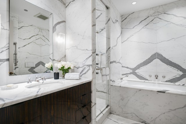 bathroom featuring plus walk in shower and vanity