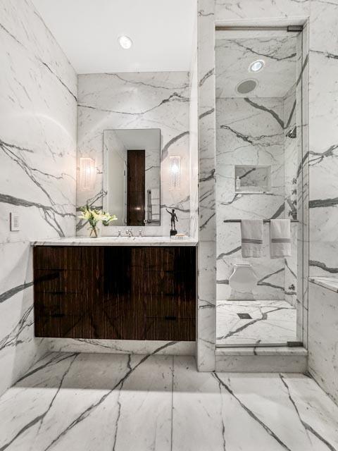 bathroom featuring vanity and a tile shower