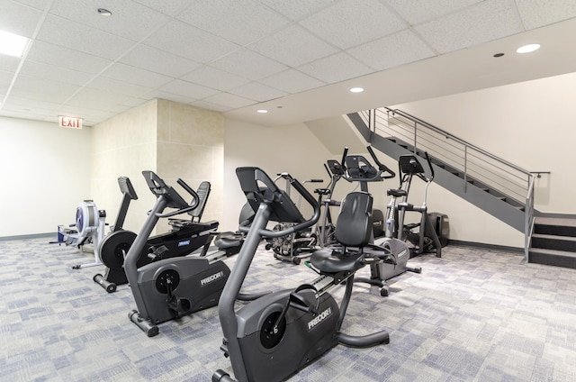 workout area with light carpet and a paneled ceiling