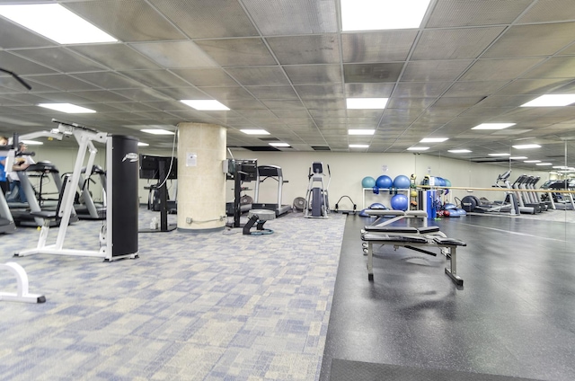 workout area with a paneled ceiling