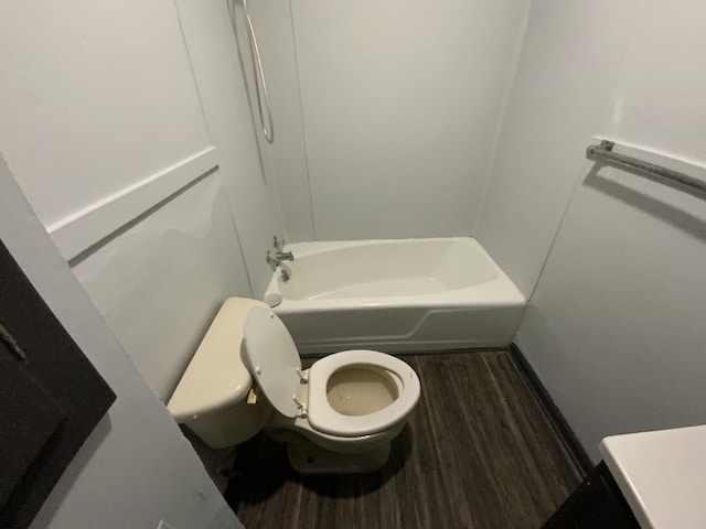 bathroom with wood-type flooring, toilet, and shower / bath combination