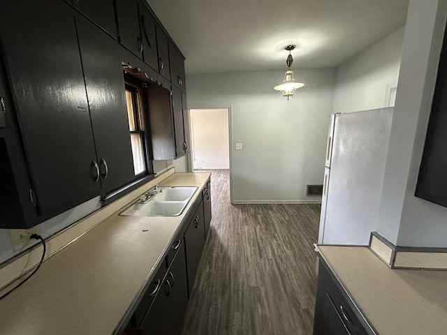 kitchen with dark hardwood / wood-style floors, decorative light fixtures, and sink