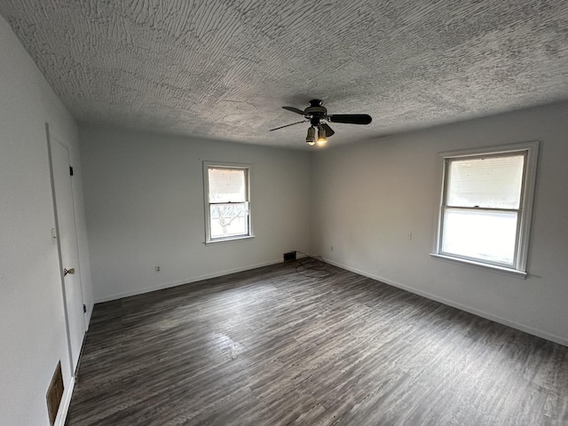 spare room with ceiling fan, dark hardwood / wood-style floors, and a textured ceiling