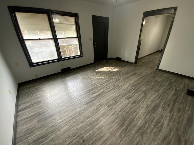 spare room with wood-type flooring