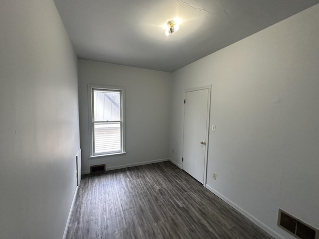 empty room featuring dark hardwood / wood-style flooring