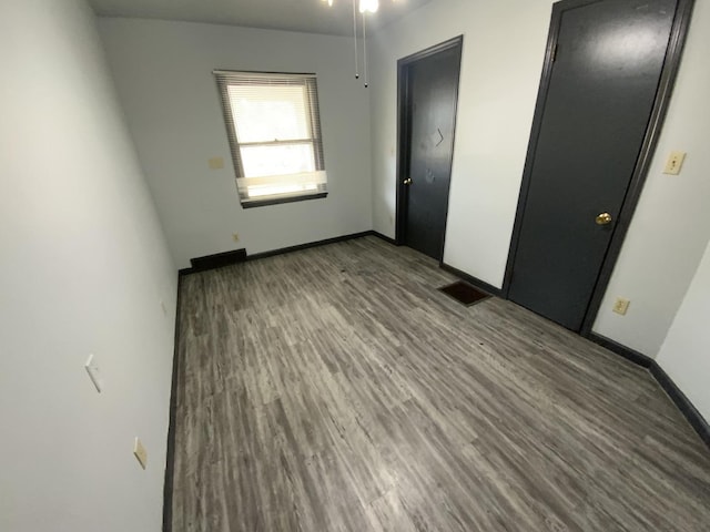 unfurnished bedroom featuring hardwood / wood-style flooring