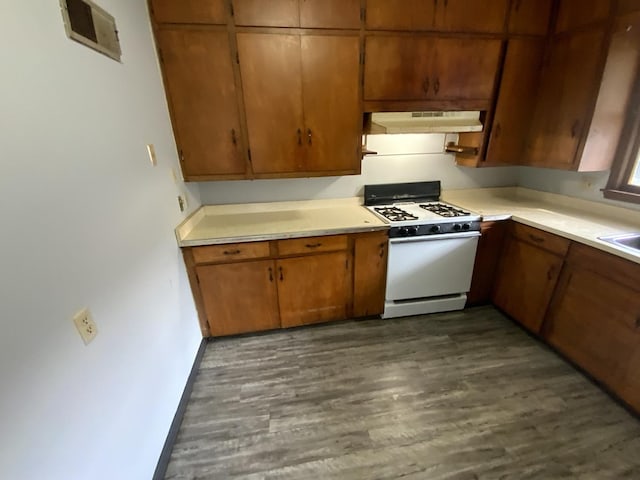 kitchen with sink, dark hardwood / wood-style floors, and white gas range oven