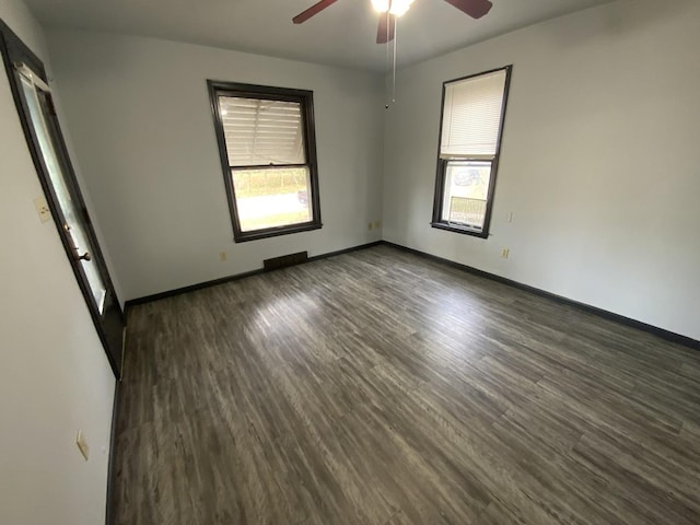 unfurnished room with dark wood-type flooring and ceiling fan