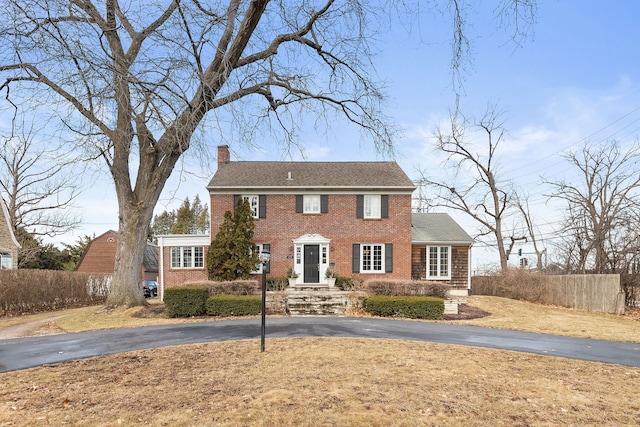 colonial-style house with a front yard