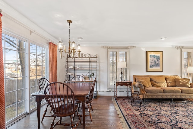 dining room featuring crown molding, dark hardwood / wood-style floors, a chandelier, and baseboard heating