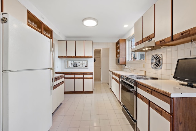 kitchen with sink, white cabinets, white appliances, and decorative backsplash