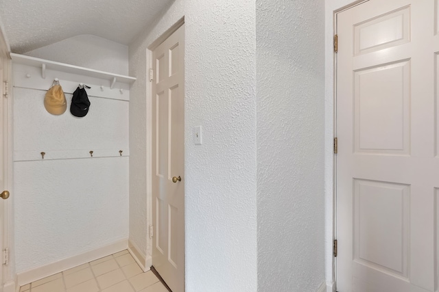 interior space with vaulted ceiling and a textured ceiling