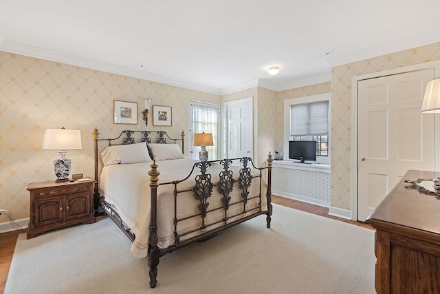 bedroom with multiple windows, crown molding, and hardwood / wood-style floors