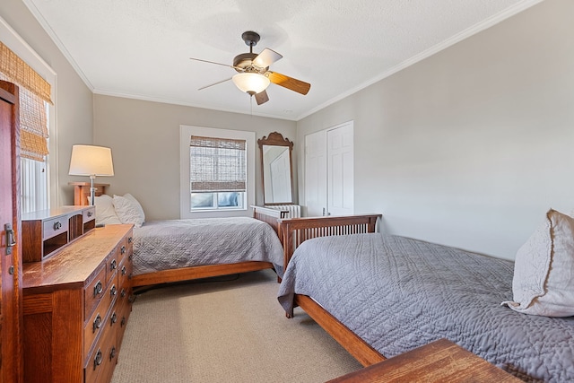 carpeted bedroom featuring crown molding, ceiling fan, a closet, and a textured ceiling