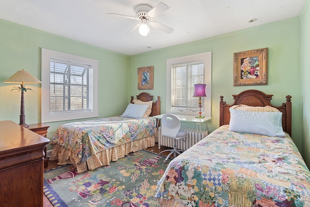 bedroom featuring ornamental molding, radiator, and ceiling fan