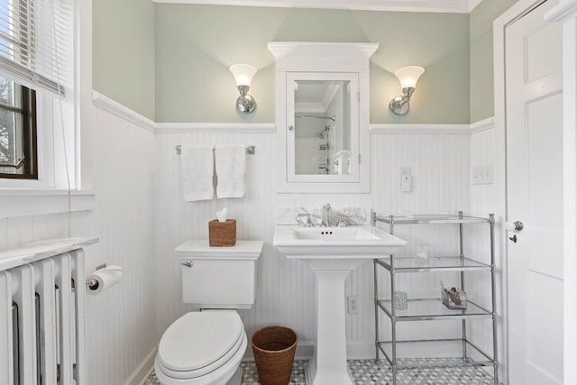 bathroom featuring radiator and toilet