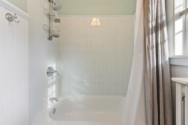 bathroom with shower / bath combo with shower curtain