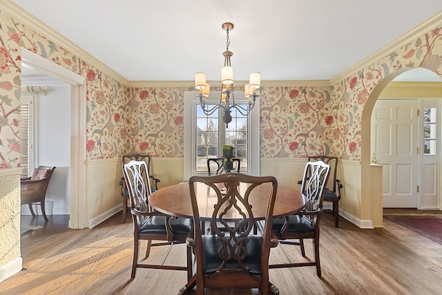 dining area with hardwood / wood-style flooring and a notable chandelier