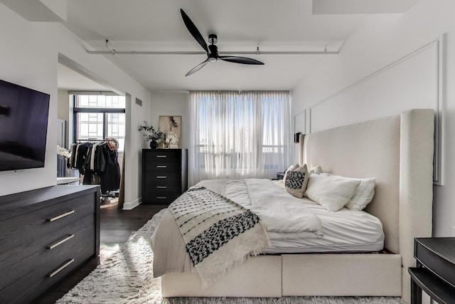 bedroom featuring dark hardwood / wood-style flooring and ceiling fan