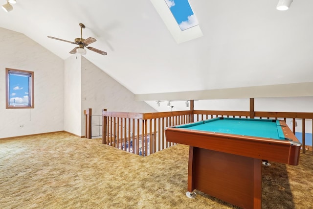 playroom with track lighting, lofted ceiling with skylight, ceiling fan, and carpet