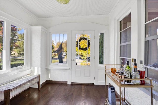 sunroom featuring vaulted ceiling and radiator