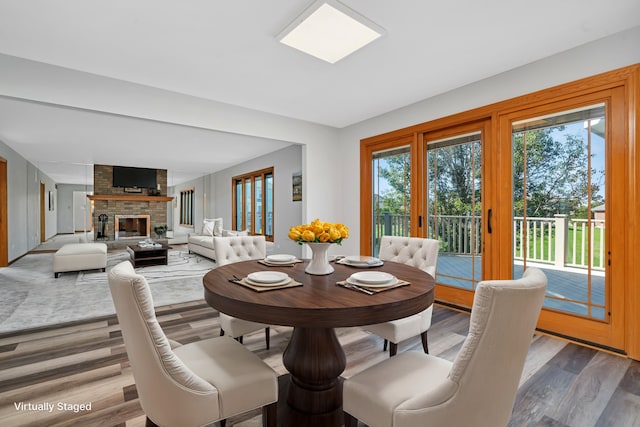 dining room featuring hardwood / wood-style flooring and a fireplace