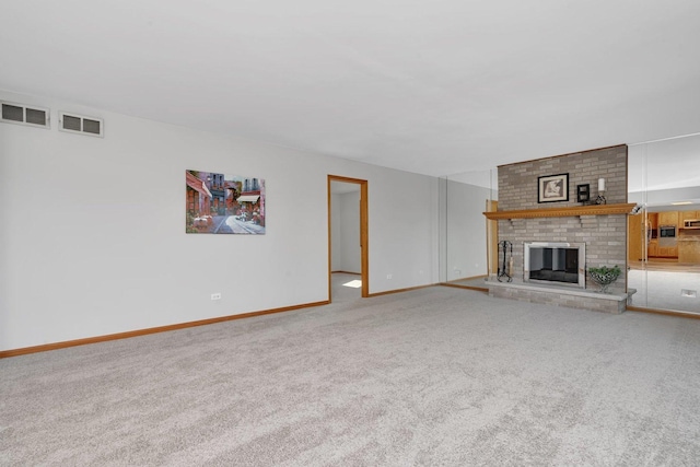 unfurnished living room featuring carpet floors and a fireplace