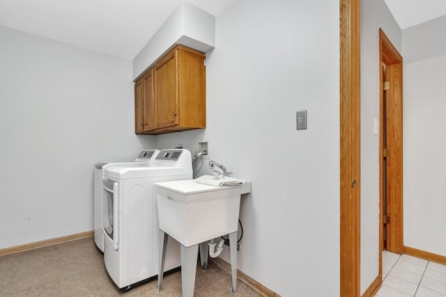 laundry room with cabinets, separate washer and dryer, and light tile patterned floors