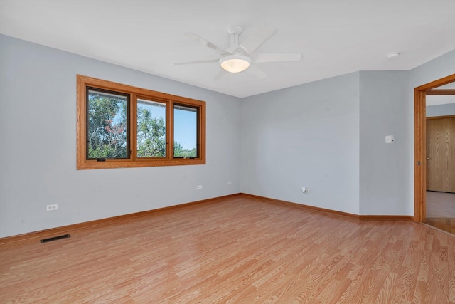 unfurnished room with ceiling fan and light wood-type flooring