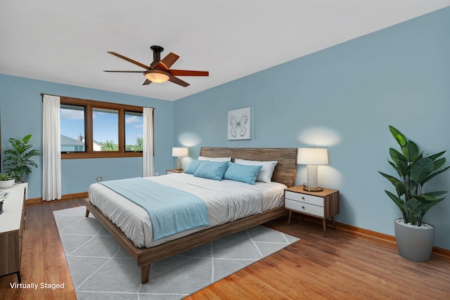 bedroom with ceiling fan and hardwood / wood-style floors