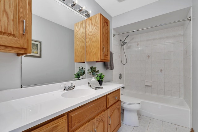 full bathroom with tiled shower / bath combo, vanity, tile patterned floors, and toilet