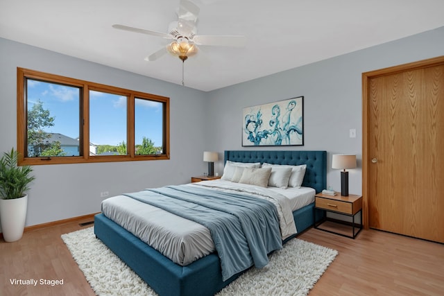 bedroom featuring light hardwood / wood-style floors and ceiling fan