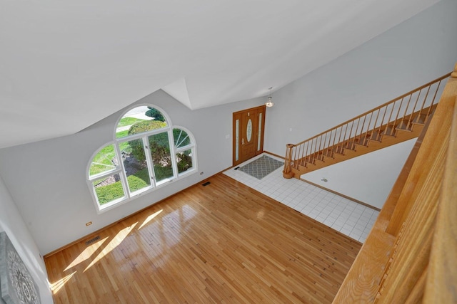 living room with vaulted ceiling and hardwood / wood-style floors