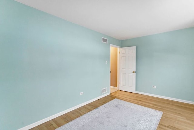 empty room with hardwood / wood-style flooring