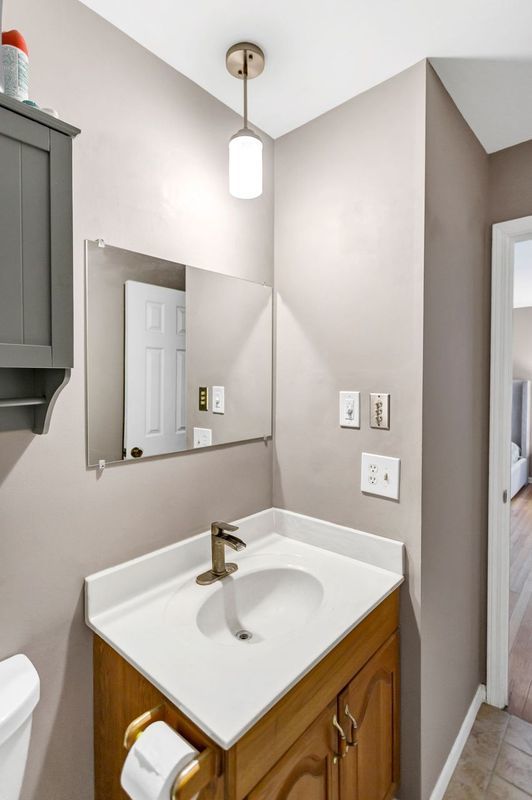 bathroom featuring vanity, tile patterned floors, and toilet