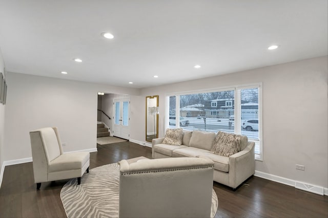 living room with dark hardwood / wood-style flooring and a wealth of natural light