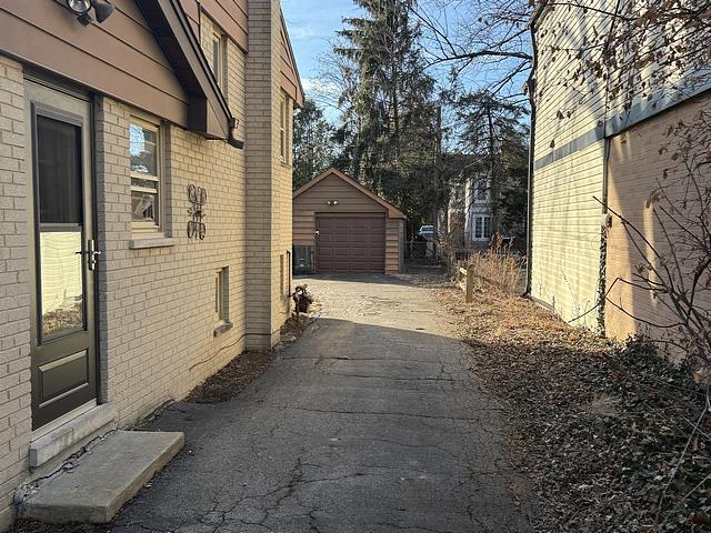 view of home's exterior with a garage and an outdoor structure