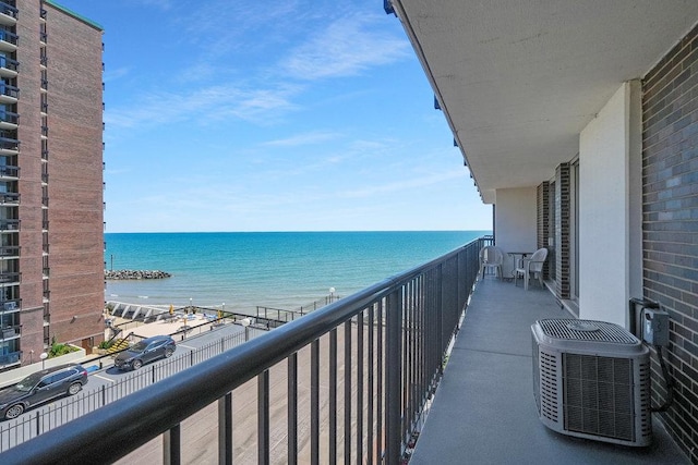 balcony with a water view and central air condition unit