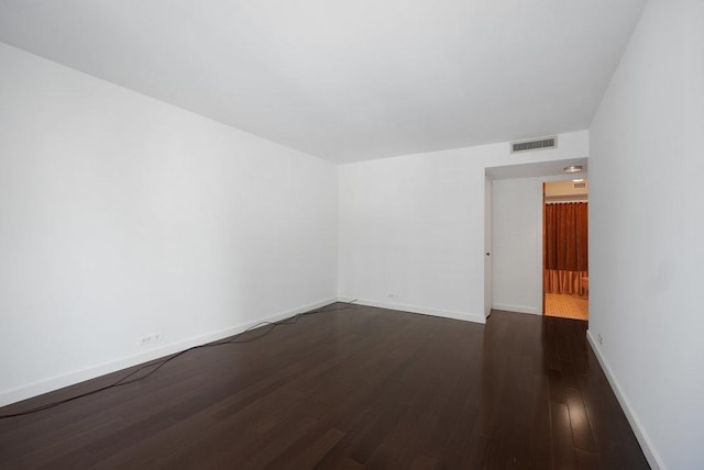 unfurnished room featuring dark hardwood / wood-style floors