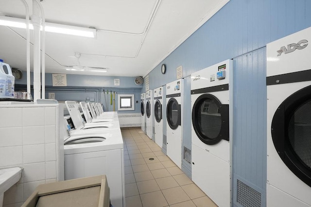 laundry area with tile patterned floors and independent washer and dryer