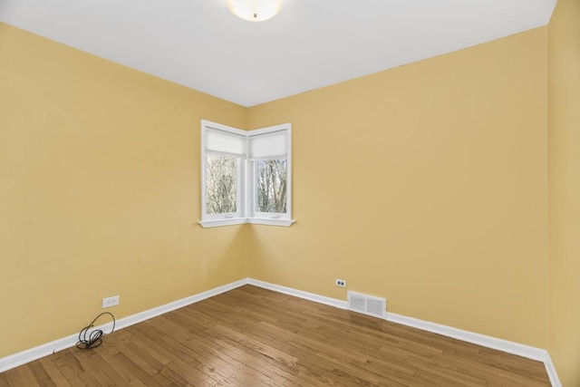 unfurnished room with wood-type flooring