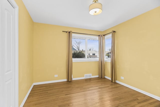 spare room featuring hardwood / wood-style floors