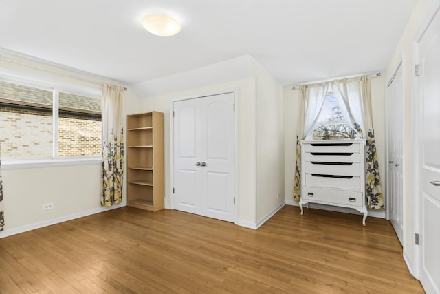 unfurnished bedroom with hardwood / wood-style floors